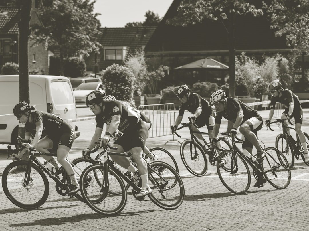 a group of people riding bikes down a street