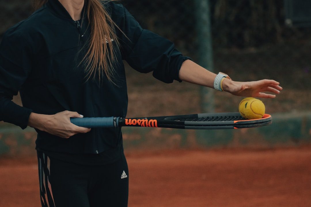 a person hitting a ball with a tennis racket