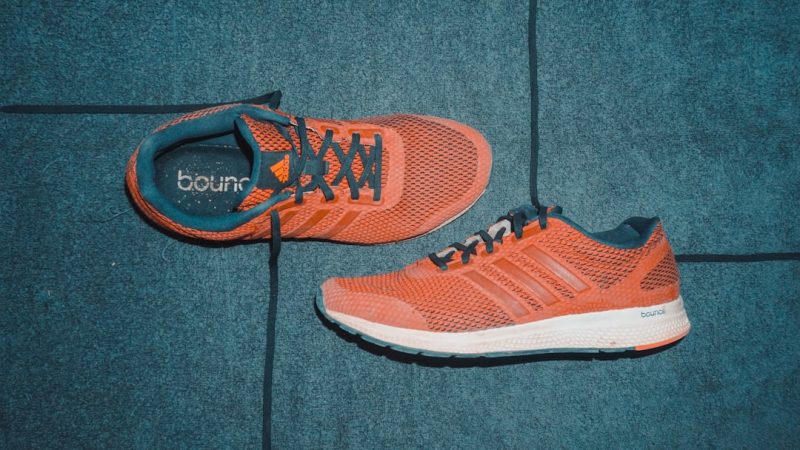 pair of orange Adidas running shoes
