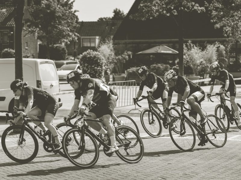 a group of people riding bikes down a street